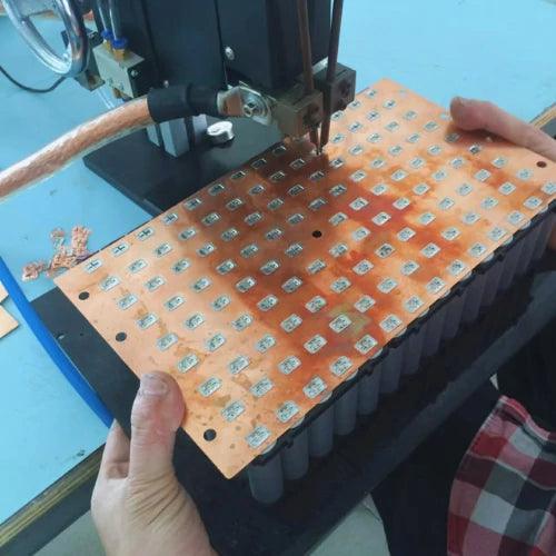 Copper-nickel composite busbar being welded onto lithium battery cells for stable energy transfer