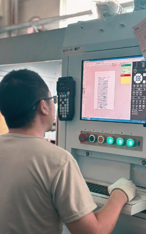 Wellgo technician operating laser cutting software for custom battery connector designs.